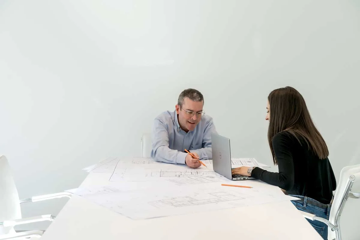 MS Architects owner at his office discussing architectural plans.